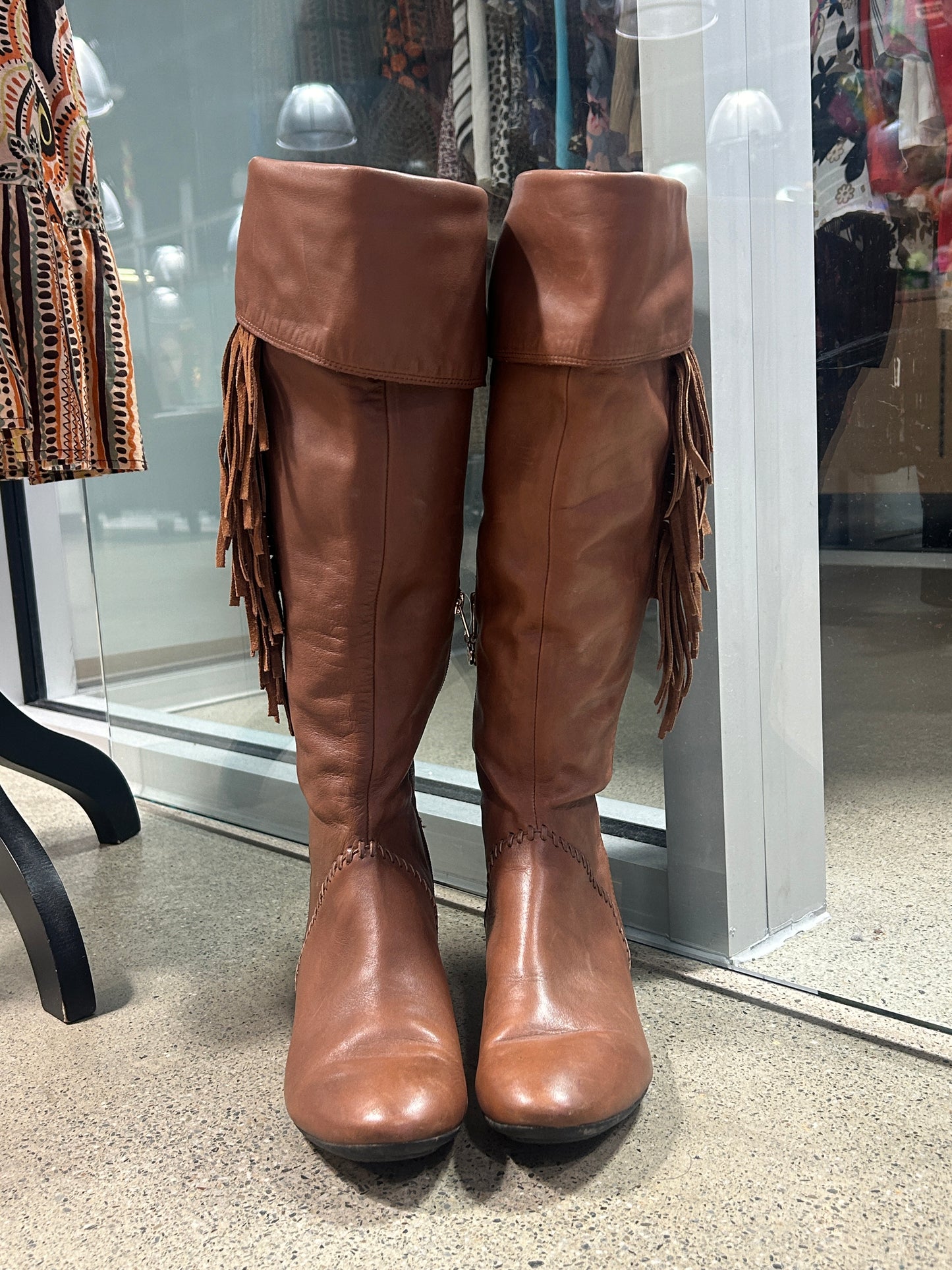 Brown leather knee-high fringe boots