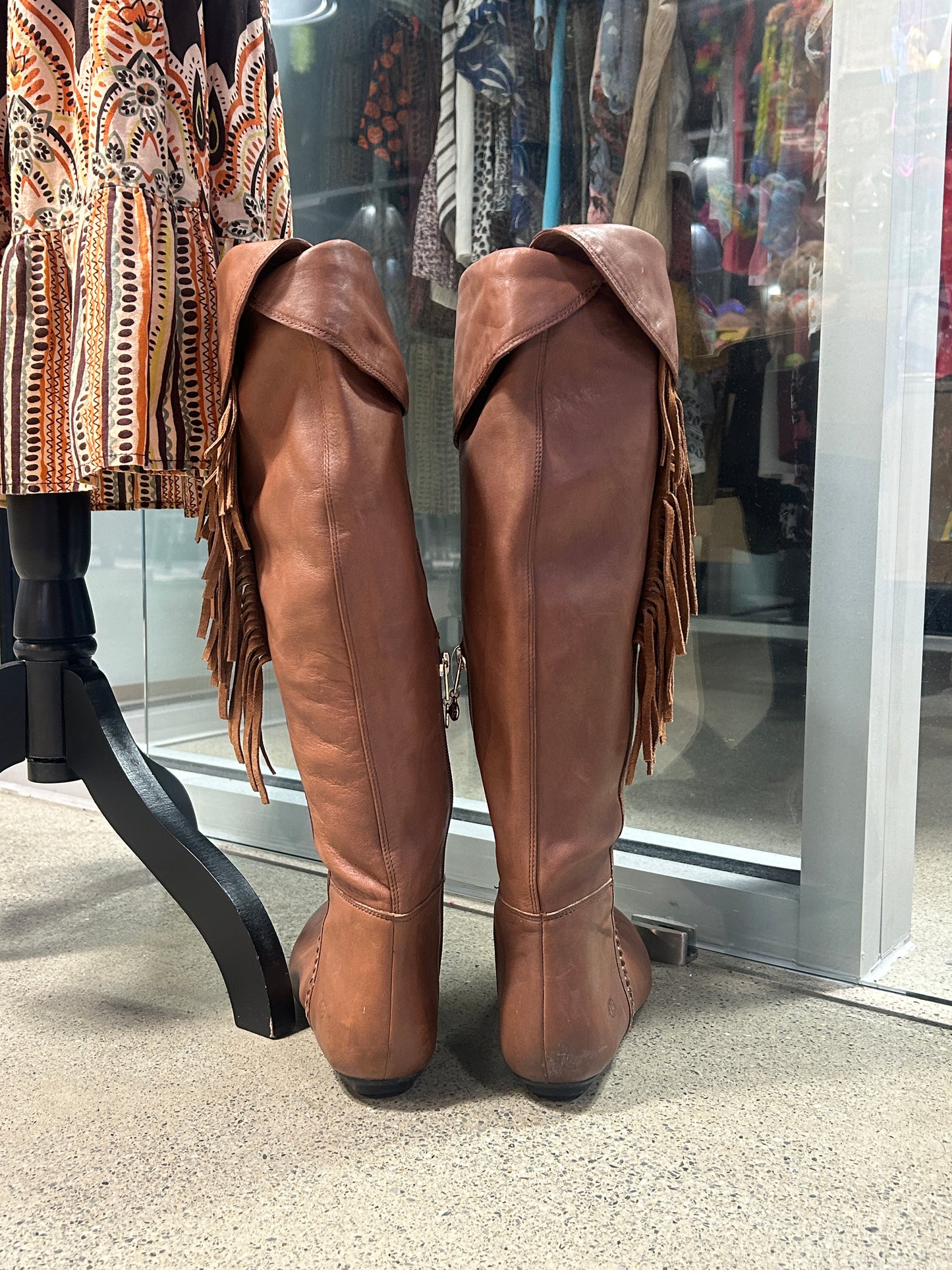 Brown leather knee-high fringe boots